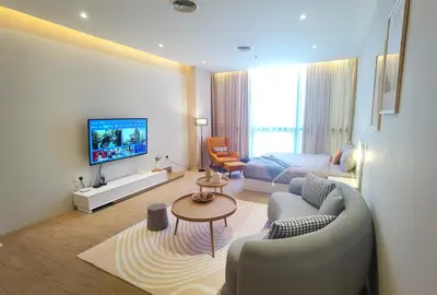 a living room with a couch and a bed at BTC The Curvena Bangsar South Mid Valley in Kuala Lumpur
