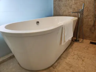 a white bath tub in a bathroom with a towel at Dorsett Residence KL Private Studio apartment in Kuala Lumpur