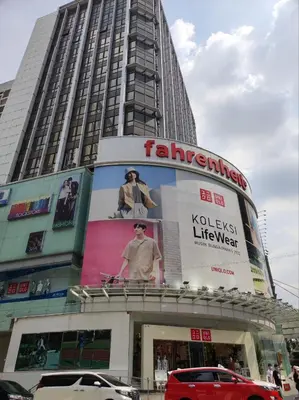 a tall building with a large advertisement on it at Dorsett Residence KL Private Studio apartment in Kuala Lumpur