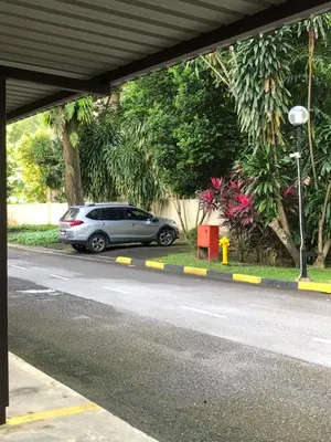 a silver car parked on the side of a road at KLCC Studio One Bedroom in Kuala Lumpur