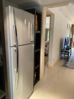 a stainless steel refrigerator in a kitchen with a hallway at KLCC Studio One Bedroom in Kuala Lumpur