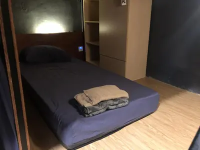 a bed with a towel on it in a room at OA ThE FACTORY AT BUKIT BINTANG in Kuala Lumpur