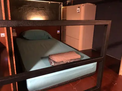 a bunk bed with two towels and a refrigerator at OA ThE FACTORY AT BUKIT BINTANG in Kuala Lumpur