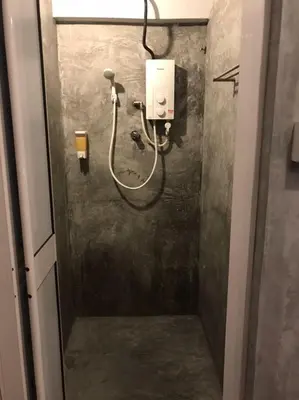 a bathroom with a hose attached to a wall at OA ThE FACTORY AT BUKIT BINTANG in Kuala Lumpur