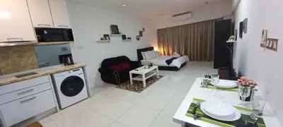 a kitchen and living room with a washing machine at ESTELAR Apartments at Mercu Summer KLCC in Kuala Lumpur