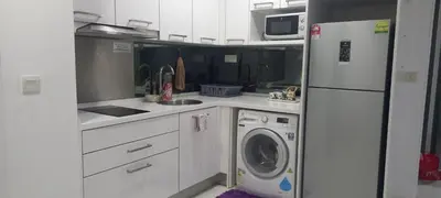 a kitchen with a refrigerator and a washing machine at ESTELAR Apartments at Mercu Summer KLCC in Kuala Lumpur