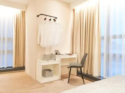 a bedroom with a desk and a chair next to a window at The Toorak @ Bangsar South Mid Valley in Kuala Lumpur