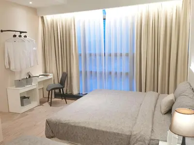 a bedroom with a bed and a desk and a window at The Toorak @ Bangsar South Mid Valley in Kuala Lumpur