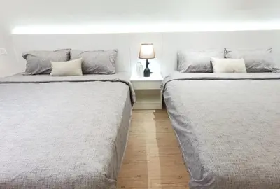 two beds sitting next to each other in a bedroom at The Toorak @ Bangsar South Mid Valley in Kuala Lumpur