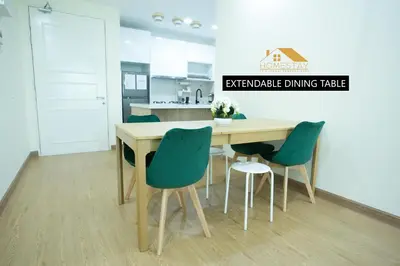a kitchen with a wooden table and four chairs at Legasi Kampung Baru by Twenty7 in Kuala Lumpur