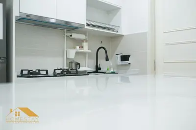 a kitchen with a sink and a stove top oven at Legasi Kampung Baru by Twenty7 in Kuala Lumpur