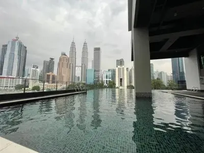 a pool of water with a city in the background at Legasi Kampung Baru by Twenty7 in Kuala Lumpur