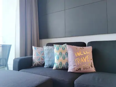 a blue couch with pillows on it with a well have on it at MyCrib45*The Robertson KL-B.Bintang in Kuala Lumpur