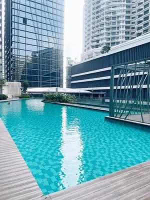 a pool of blue water in a city with tall buildings at Connected train 3 Bedrooms - ABOVE KLGATEWAY MALL 14 in Kuala Lumpur