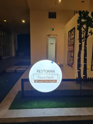 a white frisbee on the grass in front of a building at Regalia skypool 969 in Kuala Lumpur