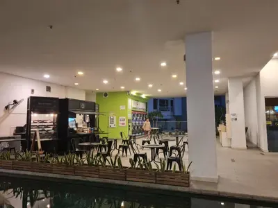 a room with tables and chairs in a building at Regalia skypool 969 in Kuala Lumpur