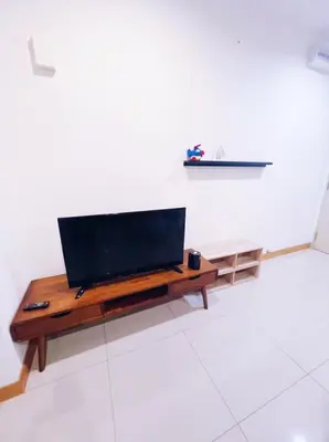 a living room with a flat screen tv on a table at Connected train 1 Bedroom ABOVE MALL-16 in Kuala Lumpur