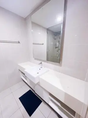 a white bathroom with a sink and a mirror at Connected train 1 Bedroom ABOVE MALL-16 in Kuala Lumpur