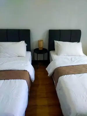 two beds sitting next to each other in a room at Omar's place 4 - Best view of KLCC Twin Towers. in Kuala Lumpur