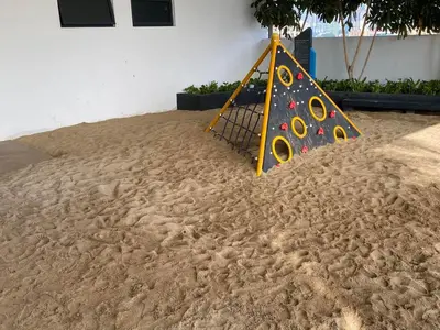 a playground in the sand next to a building at Infini Suites@ Continew Residence KL in Kuala Lumpur