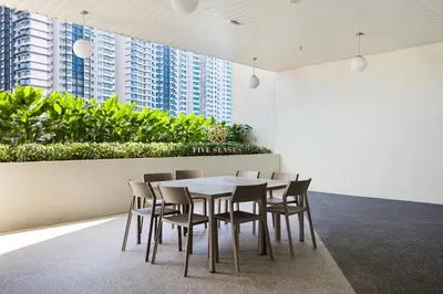 a table and chairs in a room with buildings at UNA Serviced Apartment, Sunway Velocity Kuala Lumpur in Kuala Lumpur