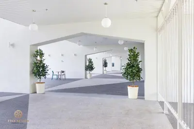a hallway with potted plants in a building at UNA Serviced Apartment, Sunway Velocity Kuala Lumpur in Kuala Lumpur