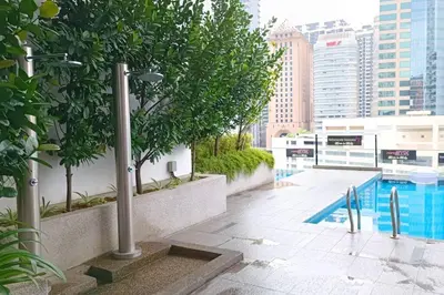 a swimming pool on the roof of a building at A05 Bukit Ceylon KL Tower View Balcony Apartment in Kuala Lumpur