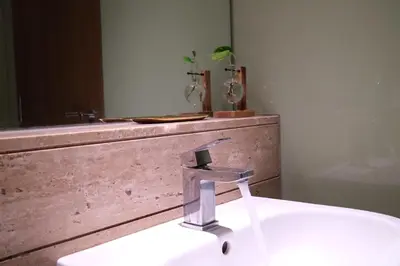 a bathroom sink with a faucet in front of a mirror at Atmoods - Vortex KLCC in Kuala Lumpur