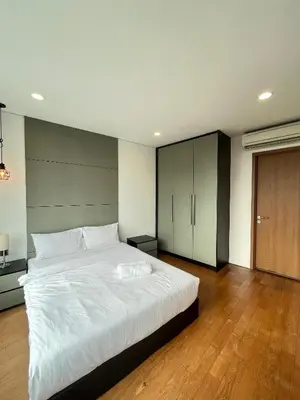 a bedroom with a large white bed and a wooden floor at Atmoods - Vortex KLCC in Kuala Lumpur