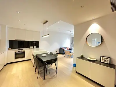 a kitchen and living room with a table and chairs at Atmoods - Star Residence in Kuala Lumpur