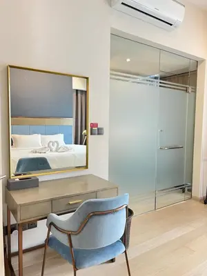 a bedroom with a desk and a bed and a mirror at Atmoods - Star Residence in Kuala Lumpur