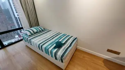 a bedroom with a bed with a blue hat on it at Majestic Apartment KLCC in Kuala Lumpur