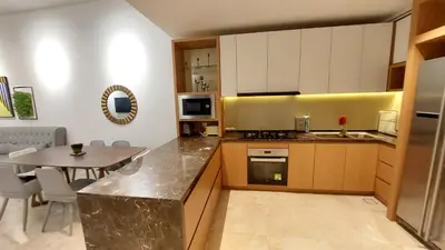 a kitchen with a table and a counter top at Majestic Apartment KLCC in Kuala Lumpur