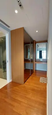 an empty living room with wood floors and a room with a mirror at Majestic Apartment KLCC in Kuala Lumpur
