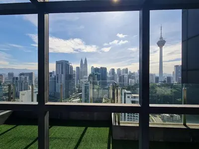 a view of a city skyline from a window at Majestic Apartment KLCC in Kuala Lumpur
