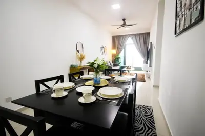a dining room with a black table and chairs at Legasi Kampung Baru by Airhost in Kuala Lumpur