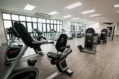 a gym with several treadmills and cardio machines at Legasi Kampung Baru by Airhost in Kuala Lumpur