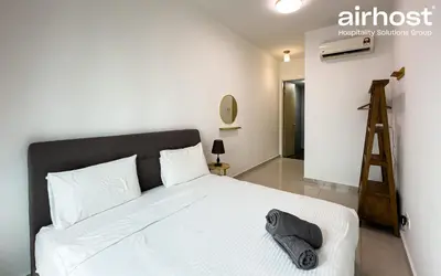 a bedroom with a white bed and a ladder at Legasi Kampung Baru by Airhost in Kuala Lumpur