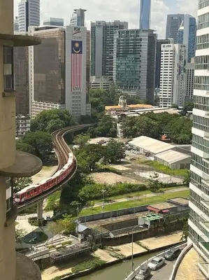 a view of a city with a train on the tracks at Charming apartment with Netflix at PWTC in Kuala Lumpur