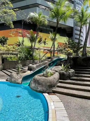 a swimming pool with a slide in a building at Charming apartment with Netflix at PWTC in Kuala Lumpur