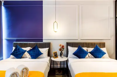 two beds sitting next to each other in a room at Scarletz Suites KLCC by Mana-Mana in Kuala Lumpur