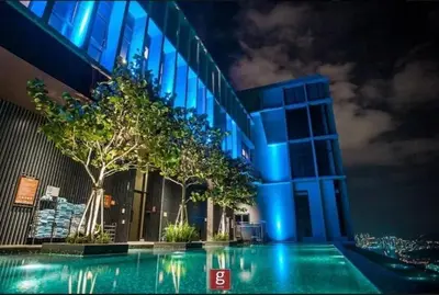 a blue building with a tree in front of it at EXPRESSIONZ by GSuites in Kuala Lumpur