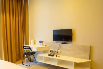 a room with a desk and a tv on the wall at EXPRESSIONZ by GSuites in Kuala Lumpur