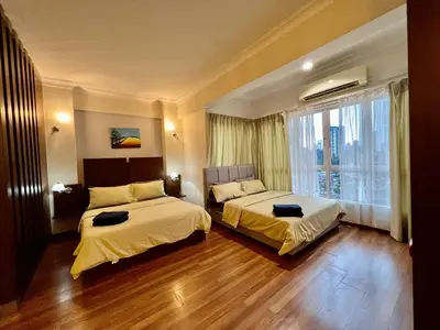 a hotel room with two beds and a window at Casa Mutiara Apartments by Moonlight in Kuala Lumpur