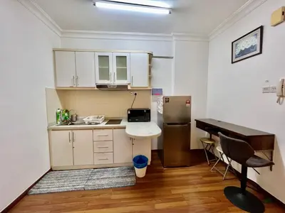 a small kitchen with a sink and a refrigerator at Casa Mutiara Apartments by Moonlight in Kuala Lumpur