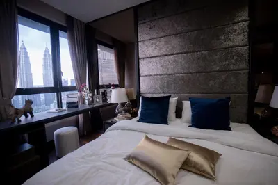 a hotel room with two beds with blue pillows at 8 Kia Peng Residences by Times 8 in Kuala Lumpur