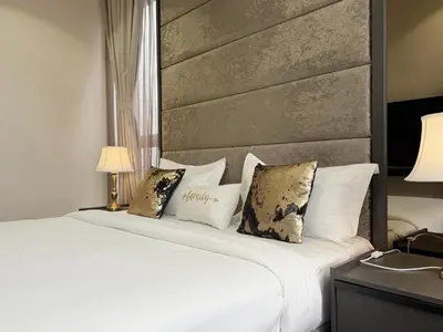 a bedroom with a large white bed with pillows at 8 Kia Peng Residences by Times 8 in Kuala Lumpur