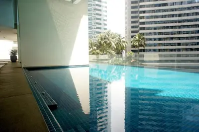a swimming pool in a building with tall buildings at KLCC Binjai 8 Premium Soho Apartment by Sarah's Lodge in Kuala Lumpur