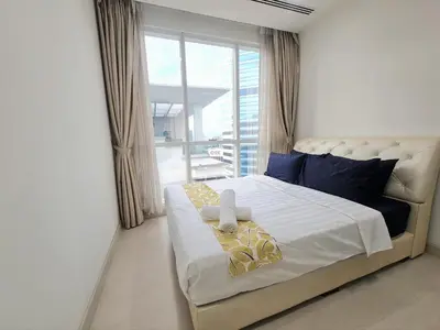 a bedroom with a large bed with a window at KLCC Binjai 8 Premium Soho Apartment by Sarah's Lodge in Kuala Lumpur