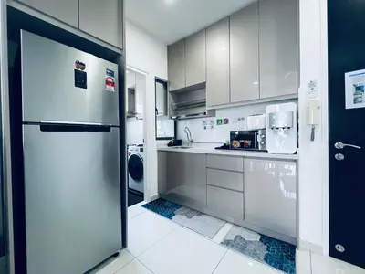 a kitchen with white cabinets and a refrigerator at Kama Homestay @Wangsa Maju in Kuala Lumpur